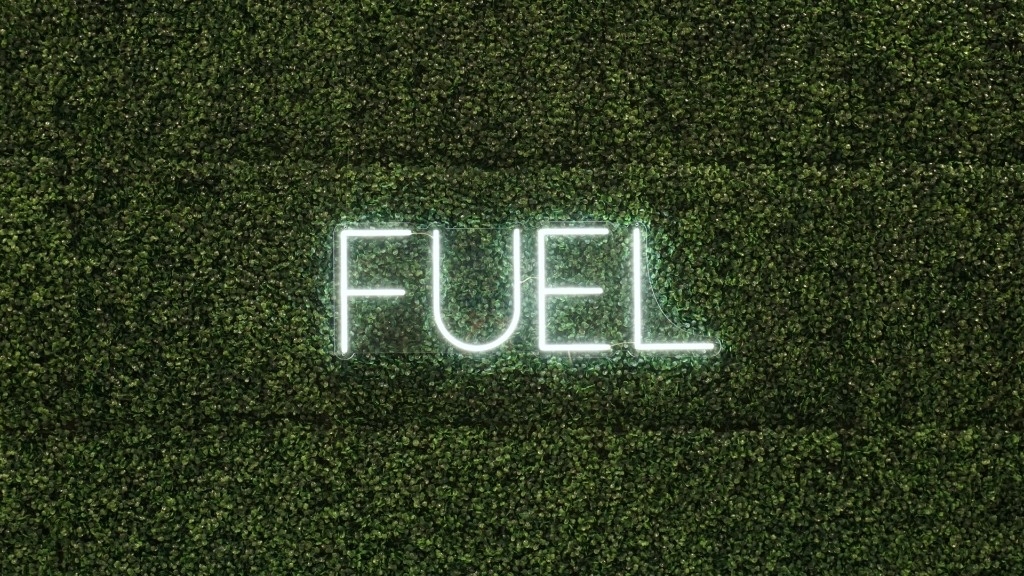 FUEL neon sign on a green moss wall